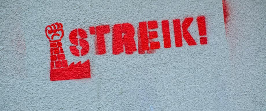 Red strike symbol painted on a wall