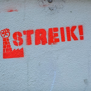 Red strike symbol painted on a wall